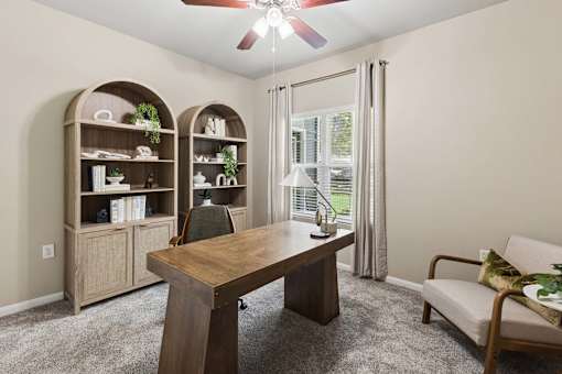 A dining room with a wooden table and chairs.