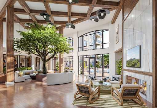A large tree in a living room with a wooden floor.