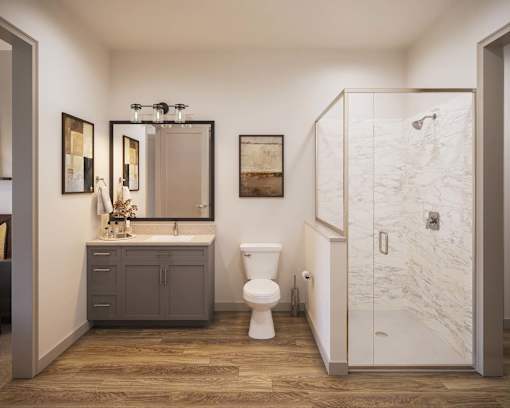 A bathroom with a toilet, sink, and shower.