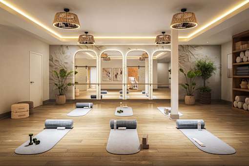 A yoga studio with mats and plants.