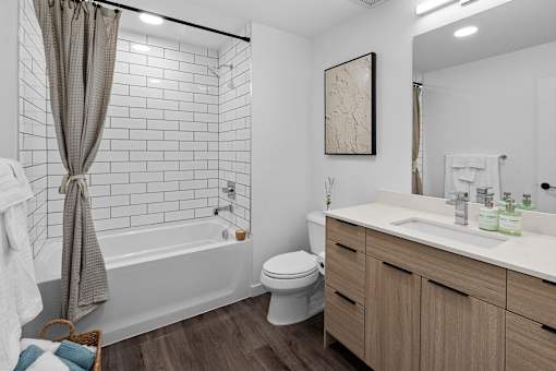 A white bathroom with a toilet, sink, and bathtub.