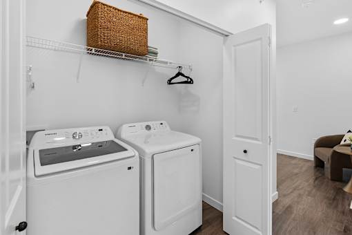 Townhomes in Bozeman, MT, with In-Unit Washer and Dryer - Highmark Bozeman - Laundry Closet With Folding Double Doors, Full-Size Energy-Efficient Washer And Dryer, And Wire Rack Shelf.