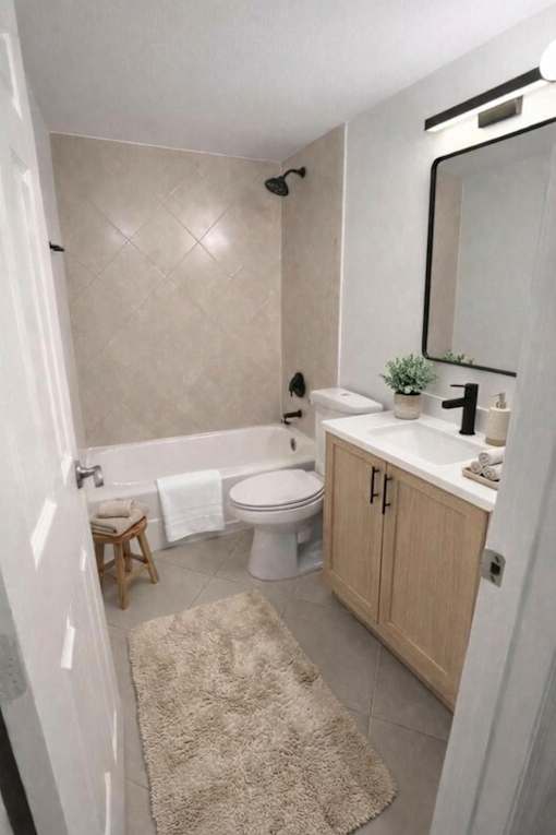A bathroom with a white tub, toilet, and sink.