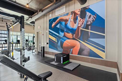 A woman is running on a treadmill in a gym.