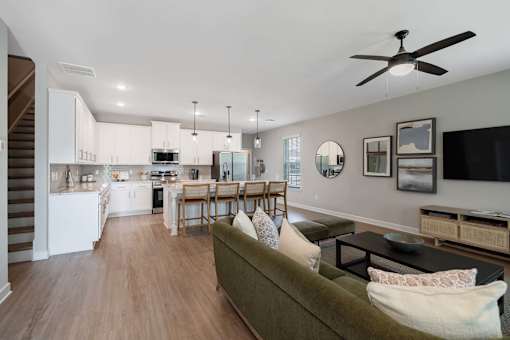 A living room with a couch and a dining table.