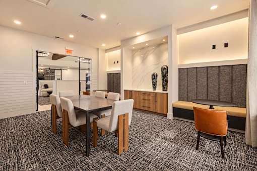 A conference room with a long table and chairs.