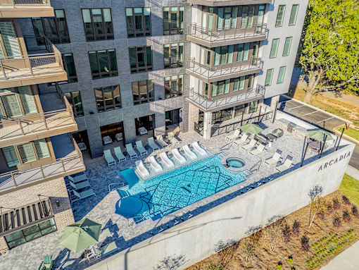 A large building with a pool in front of it.