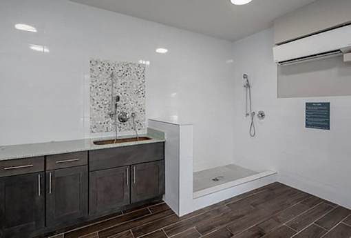 A bathroom with a shower and a sink.