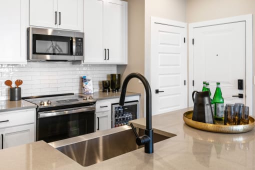 a kitchen with stainless steel appliances and white cabinets