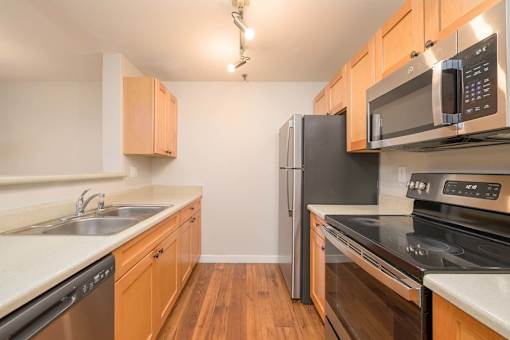 A kitchen with wooden cabinets and stainless steel appliances.