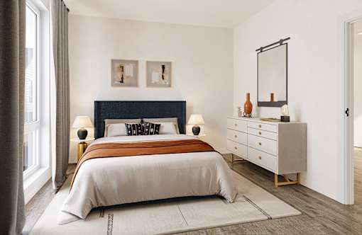 Dog-Friendly Townhomes in Bozeman, MT - Highmark Bozeman - Bright Bedroom With Large Window, Gray Curtains, Upholstered Headboard, White Dresser, Wall Mirror, And Wood Style Flooring.