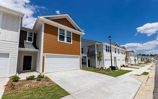 a row of townhomes with white and brown siding
