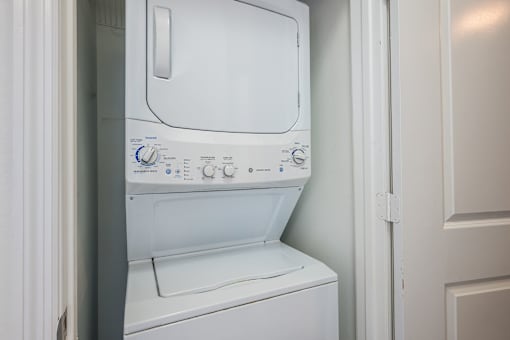 A white washing machine with a blue and white control panel.