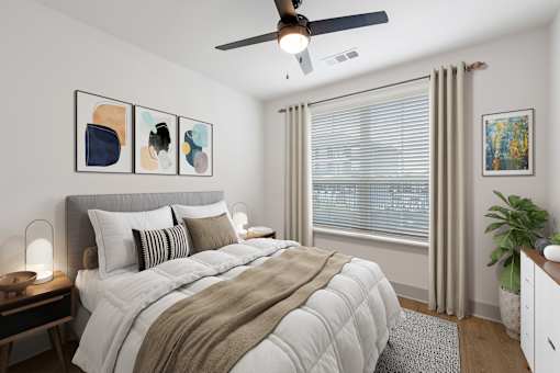 One-Bedroom Luxury Apartments in Huntsville, AL - The Kelvin - Bedroom with Luxury Vinyl Tile Flooring, Area Rug, Bed, Nightstands with Lamps, Dresser, Ceiling Fan, Potted Plant, and Spacious Window.