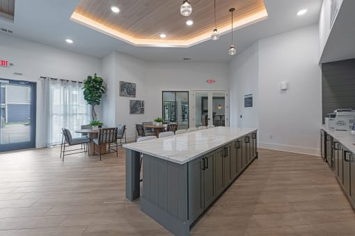 a large kitchen with a center island and a dining room with tables and chairs