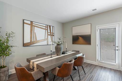 a dining room with a long table and chairs