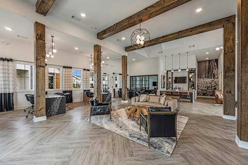 a large living room with wood beams and furniture