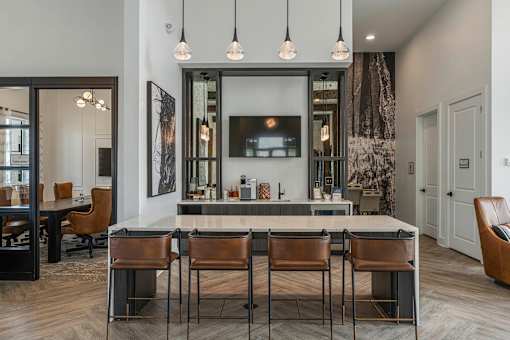 a kitchen with a counter top and chairs