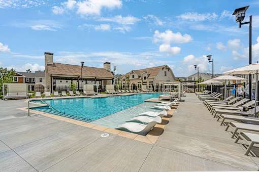 the resort style pool is surrounded by lounge chairs