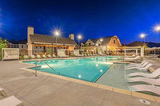 the resort style pool is lit up at night