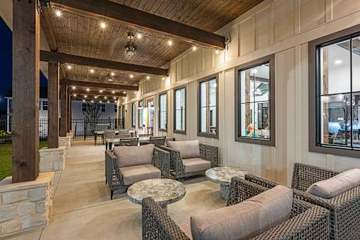 a lobby with chairs and tables and windows