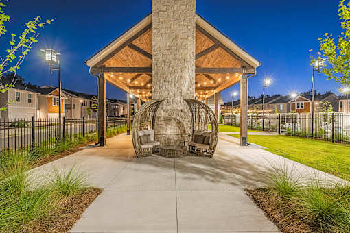 the preserve at ballantyne commons clubhouse with fire pit at night