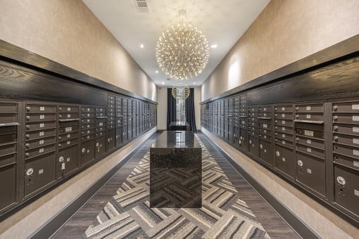 a long hallway filled with wine lockers and a large chandelier