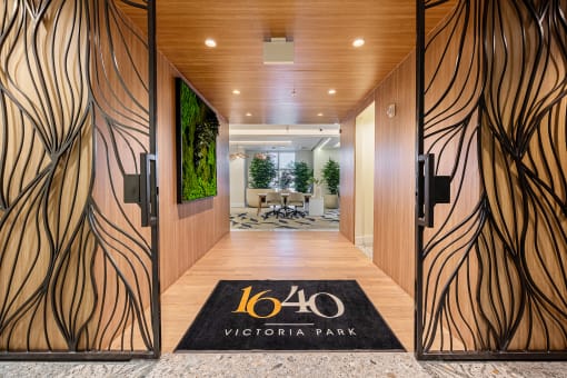 a hotel lobby with wooden doors and a sign that reads 160 victory park