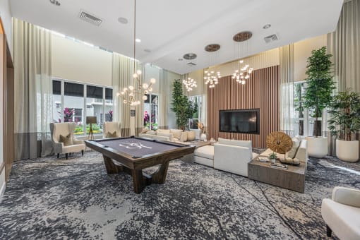 a living room with a pool table in the center
