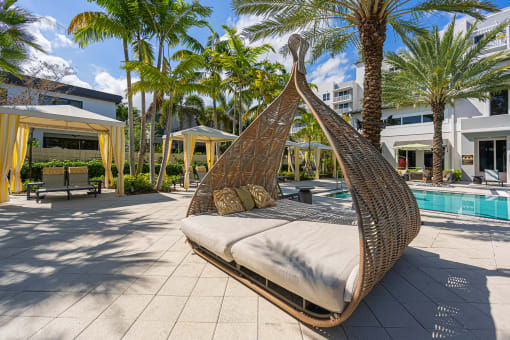 a hanging hammock in a pool area at a resort