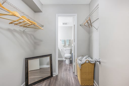 a bathroom with a toilet and a mirror in a small room