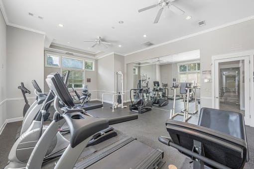 a gym with treadmills and other exercise equipment
