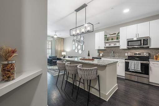 a kitchen and living room with an island and stools