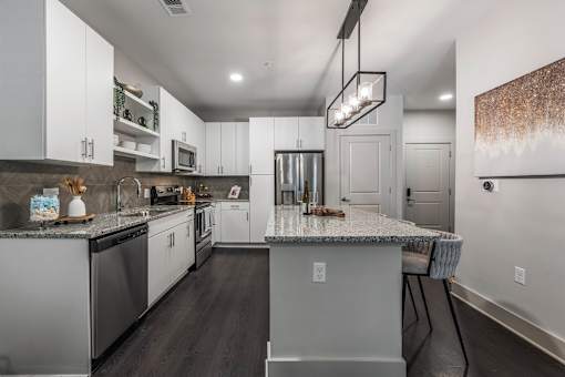 a kitchen with white cabinets and a counter top