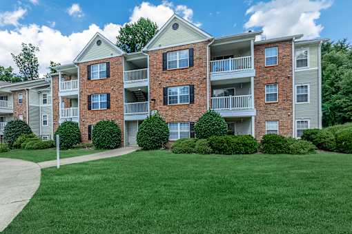Apartment building with a green lawn in front.