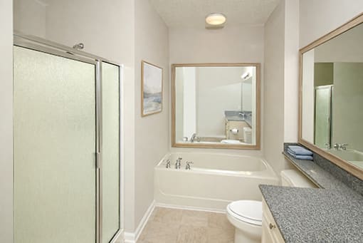 A bathroom with a toilet, sink, and bathtub.
