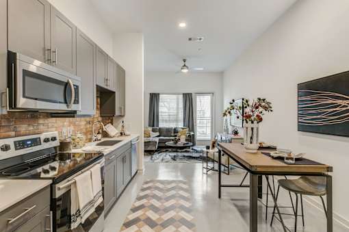 A modern kitchen with a black and white checkered floor.