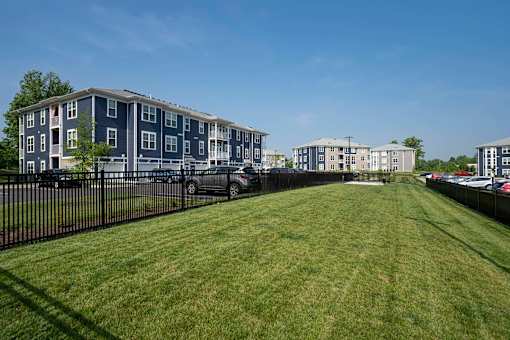 A grassy area in front of apartment buildings.