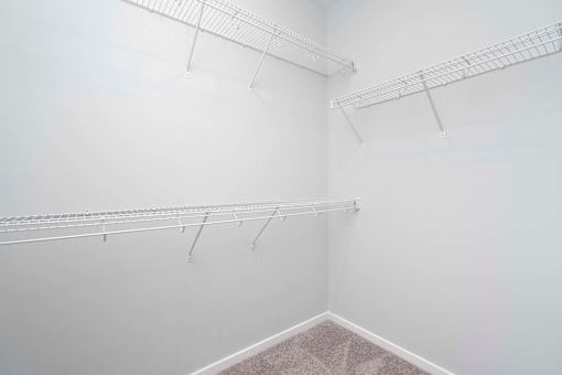 A white room with three metal racks on the wall.