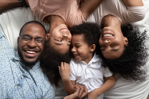 Square One family laying in bed
