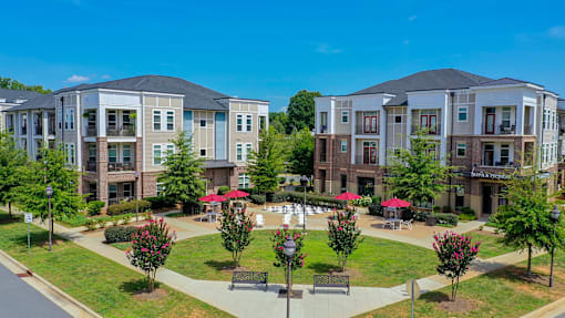 A sunny day at a residential complex with a park in the middle.