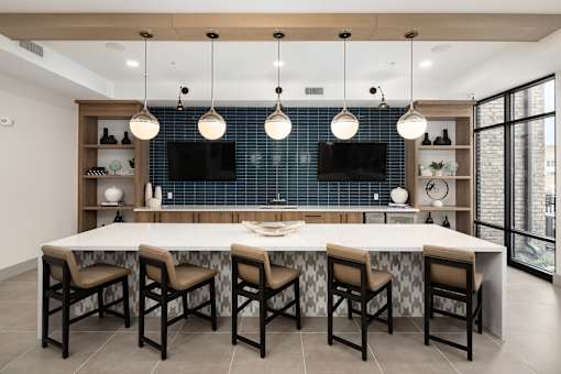 A modern dining room with a large table and chairs.
