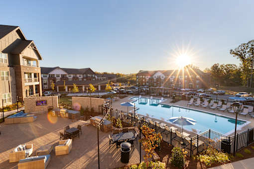 A sunny day at the pool with a sunset in the background.