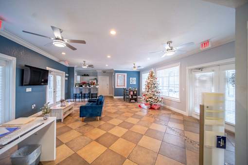 A living room with a Christmas tree and a checkered floor.