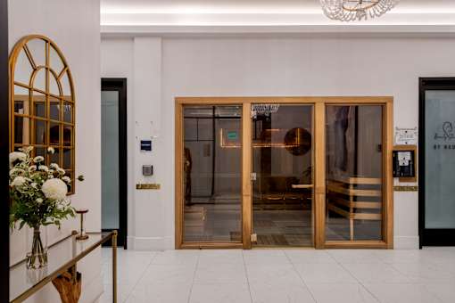 A glass door with a gold frame is the main focus of the image.