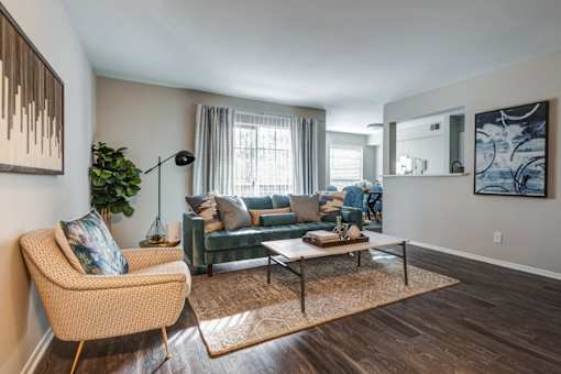 A living room with a sofa, armchair, and a coffee table.