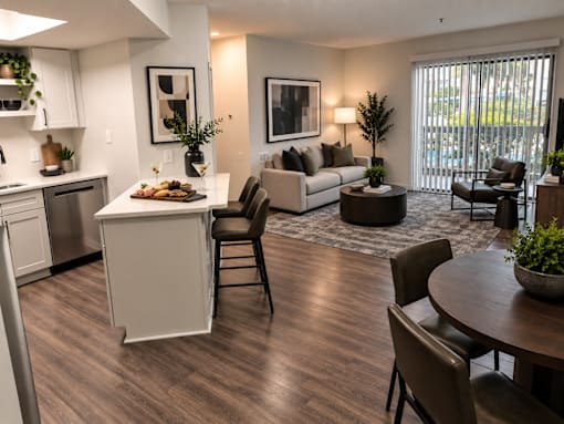 A modern kitchen with a dining table and chairs.