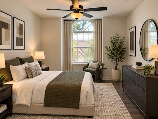 A bedroom with a large bed and a ceiling fan.