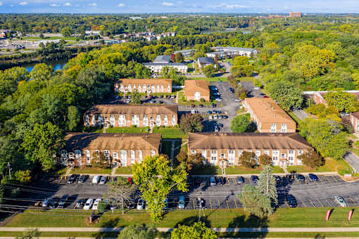 A large building complex with a parking lot in front.