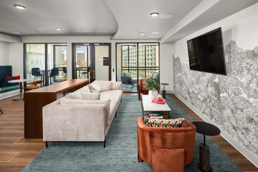 a living room with couches and a tv on the wall